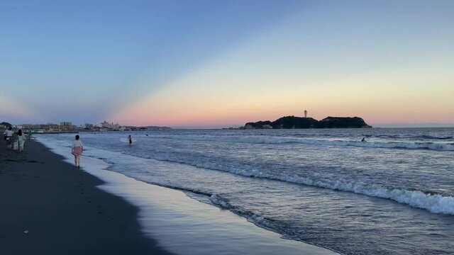 FUJISAWA, KANAGAWA, JAPAN - JULY 2021 : View of beach and magic hour sky at Shonan area near Enoshima island. Wide view, real time shot in dusk.