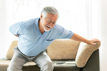 Elderly patients on couch , Asian senior man suffering from back pain  - medical and healthcare concept