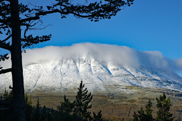 Clouds over snowy mountain