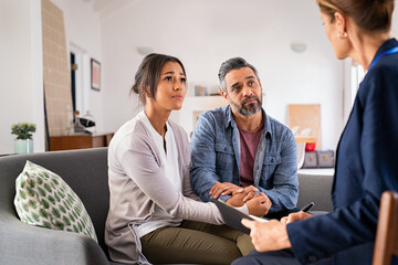 Worried couple meeting social counselor