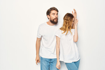 funny man and woman in white t-shirts are standing side by side friendship communication