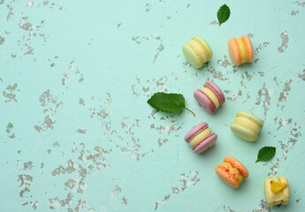 baked macarons with different flavors on a green background