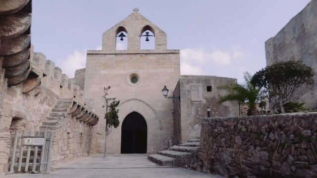 A medieval church with bells in the Castle of Capdepera, Spain