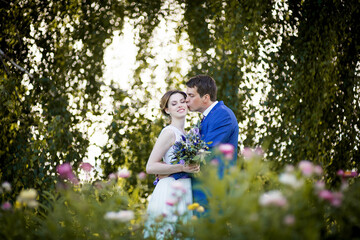 Happy young bride and groom on  wedding day. Wedding couple - new family! wedding dress. Bridal wedding bouquet of flowers