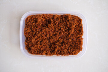 Chicken Floos (abon ayam) in a box. Top view on white