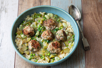 Green minestrone sopu with meat balls and orzo pasta
