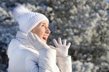 Happy beautiful senior woman in warm hat