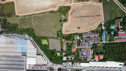 Factory roof from aerial bird eyes view. Area of large plant from top view with space of industrial and green area around.