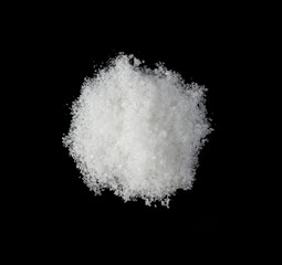 Obraz na płótnie Canvas the pile white sugar on a black background 