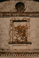 detail of abandoned old church building in Latvia, window with built in bricks