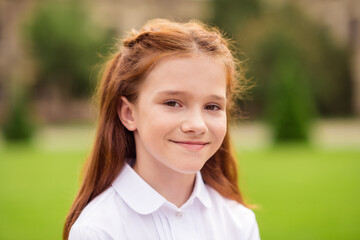 Photo of positive cheerful adorable cute ginger schoolgirl look camera smile wear white shirt...