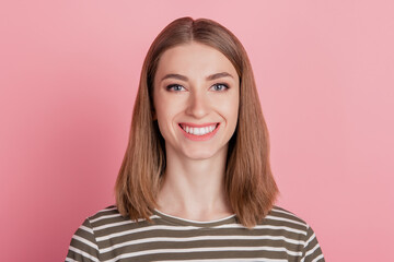 Fototapeta premium Portrait of positive charming lady beaming white smile look camera on pink background