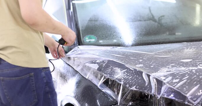Covering car with protective film to protect it from scratches and scuffs 4k movie