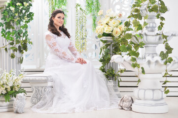 portrait of young beautiful bride in white dress posing