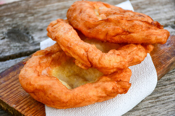 Traditional Bulgarian home made deep fried  patties  covered with sugar  оn rustic backgroud.Mekitsa or Mekica,  on wooden  rustic  background. Made of kneaded dough that is deep fried 