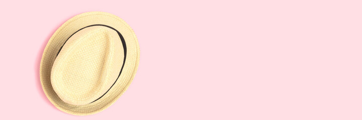 Banner with straw hats on a pink pastel background. Summer concept with copyspace.