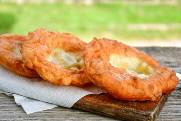 Traditional Bulgarian home made deep fried  patties  covered with sugar  оn rustic backgroud.Mekitsa or Mekica,  on wooden  rustic  background. Made of kneaded dough that is deep fried 