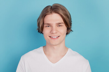 Portrait of smiling guy isolated on blue background