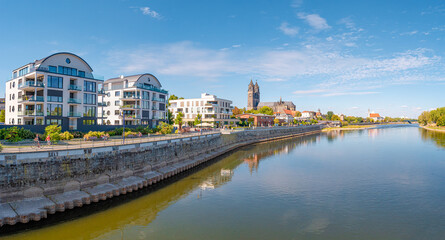 Naklejka premium Panoramic view over historical downtown of Magdeburg, old town, Elbe river, new modern houses and Magnificent Cathedral at early Autumn with blue sky and sunny day, Magdeburg, Germany.