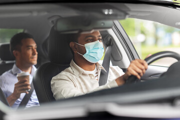 transportation, health and people concept - indian male taxi driver driving car with passenger wearing face protective medical mask for protection from virus disease
