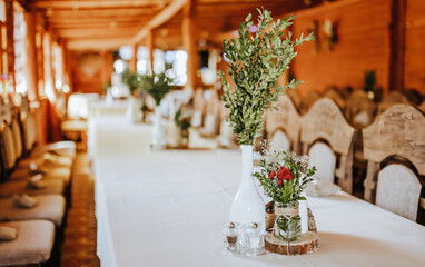 Wedding banquet decoration. Place for the guests decorated with flowers and plants at the party