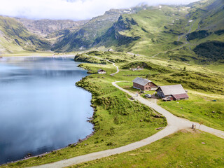 Aerial image of hiking path along the mountain lake over the Engelberg in Switzerland. It is a popular recreational area offering rich outdoor activities.