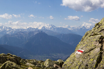 Hiking trails on the Swiss Alps, marked by a red and white bars as more challenging routes. These signs are set by the Swiss Hiking Association.