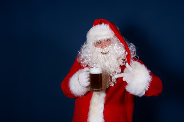 Funny santa claus drinks beer.