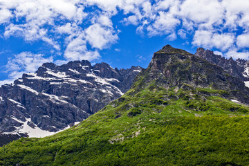 Fototapeta premium Mountains of the North Caucasus of Russia. Russian nature. Green valleys panoramic view. In the clouds and fog.