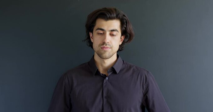 Handsome Guy Smoking After Coronavirus, Take Off The Medical Mask And Smoke, Young Caucasian Brunette Male In Black Shirt Isolated On Black Studio Background. Healthcare, COVID-19. Copy Space