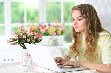 Portrait of  young  woman working with laptop