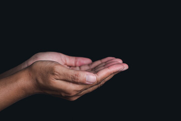 Hands isolated on black background. Hands concept. Outstretched hand. Side view. Dark background