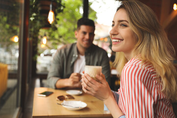 Lovely couple spending time at cafe in morning