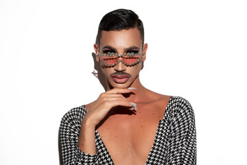 beautiful drag queen with mustache, glasses and acrylic nails posing glamorously on a white...