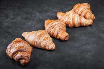 croissants lie on the black breakfast table