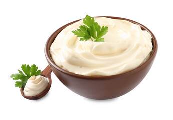 Spoon and bowl of delicious mayonnaise with parsley on white background