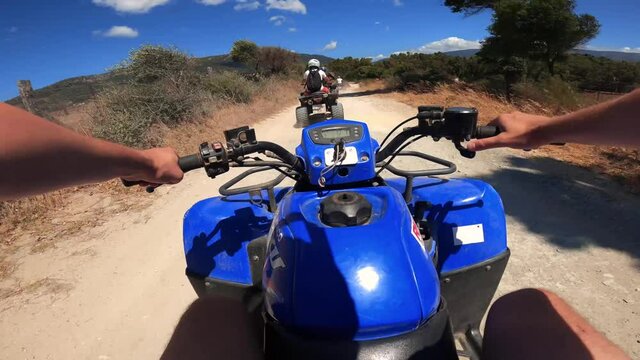 Driving an ATV on off-road in Spain. First-person view on an action camera. Point of view, POV riding Quad ATV through the forest. Adventures of off-road on ATVs. 