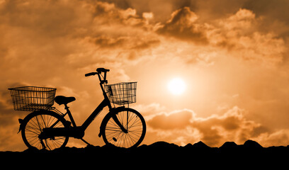 Bicycle silhouette at sunset with cloudy.