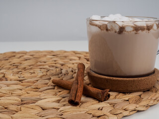 Cocoa marshmallows in flat style on white background. Wooden background. Flat lay view.