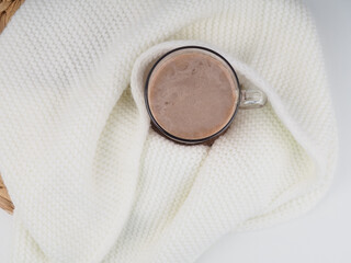 Cocoa marshmallows in flat style on white background. Wooden background. Flat lay view.