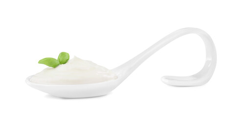 Delicious sour cream with basil in ceramic spoon on white background