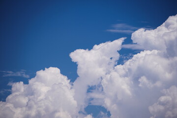 Angelic clouds descending into the clear sky