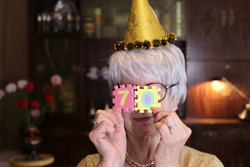 Senior woman celebrating 70th anniversary with joy