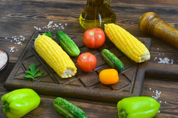 food background and ingredients for cooking summer salad, pink salt mineral, tomato, cucumber, mill...