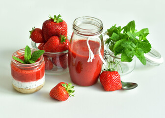 Homemade cheesecake with strawberry and cottage cheese cream in a glass jar.fresh green lime, mint and chia on white background.summer dessert without baking