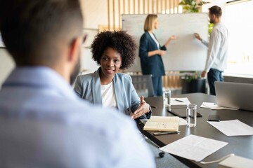 Black businesswoman speaking with colleague