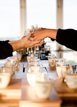 Bartenders Passing Glassware with Hands