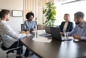 Employees listening to African American boss