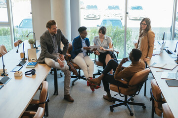 Group of Businesspeople in a Casual Meeting at their Company.

Team of five multi-ethnic employee...