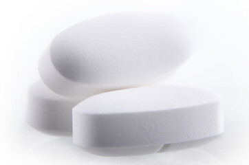 Composition with pharmaceutical drug pills over white background